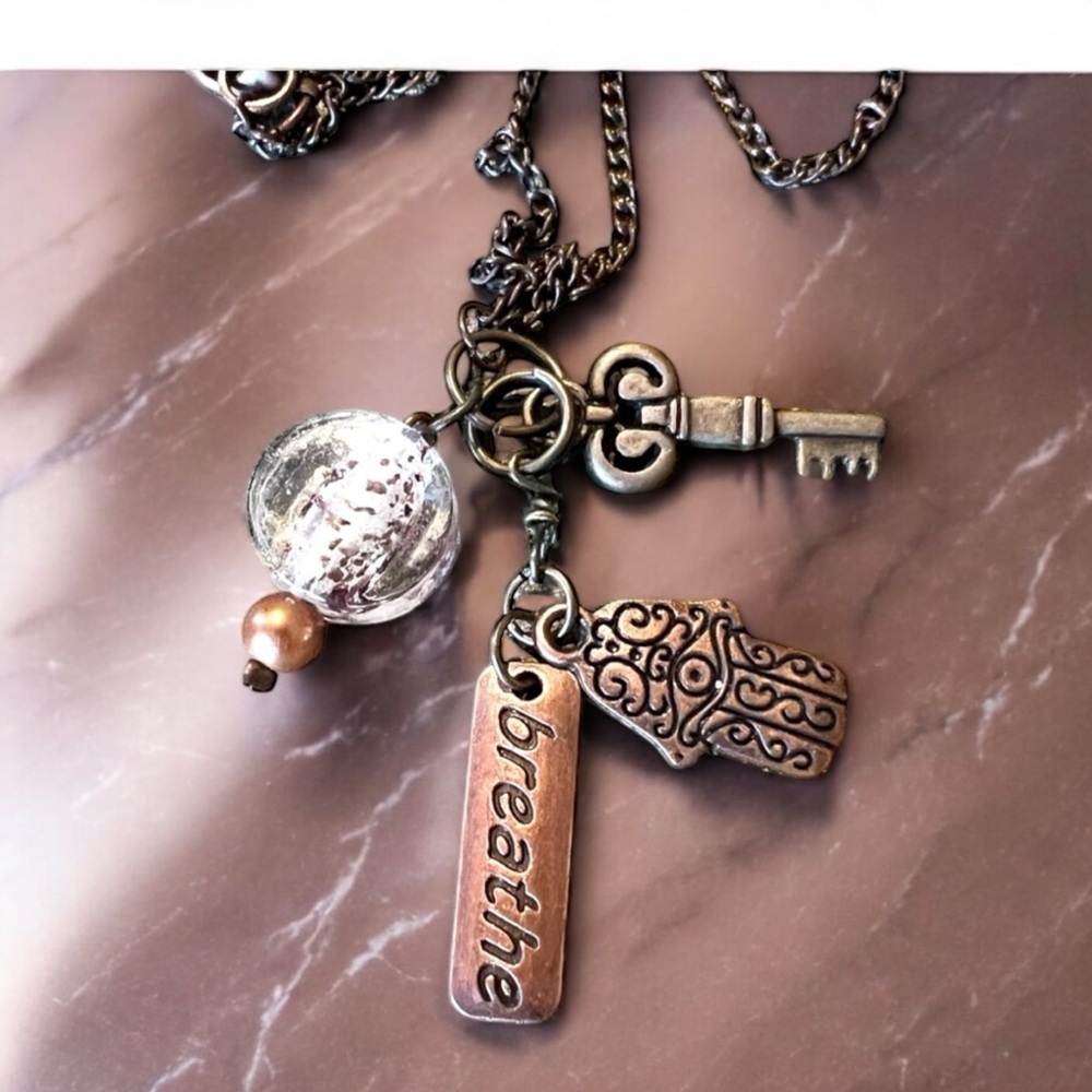 Unique bronze necklace key and charm details clear glass bead and 'breathe' tag. - Picture 10 of 15